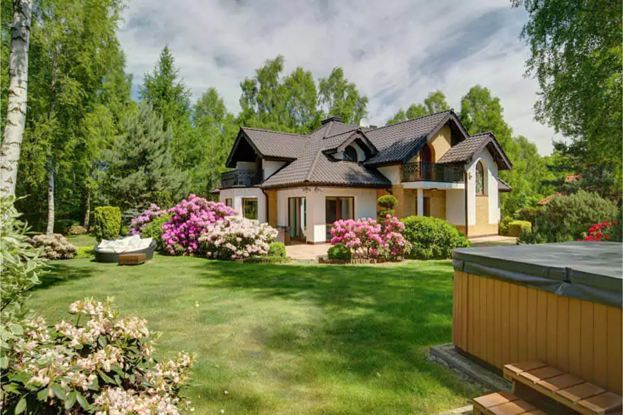 A beautiful house around with green big trees